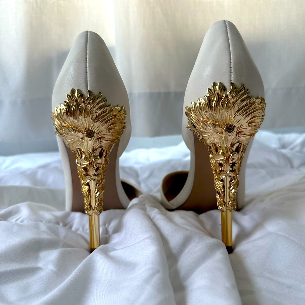 White pumps with gold embellished heels